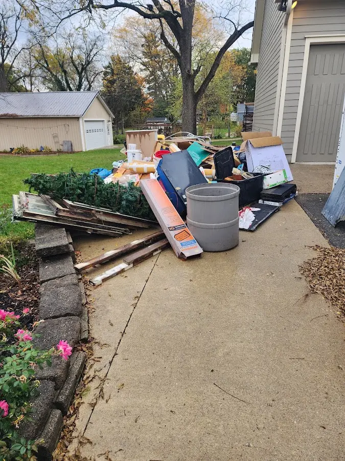 Dumpster being loaded with debris for Estate Cleanout Dumpster Rental in Prien
